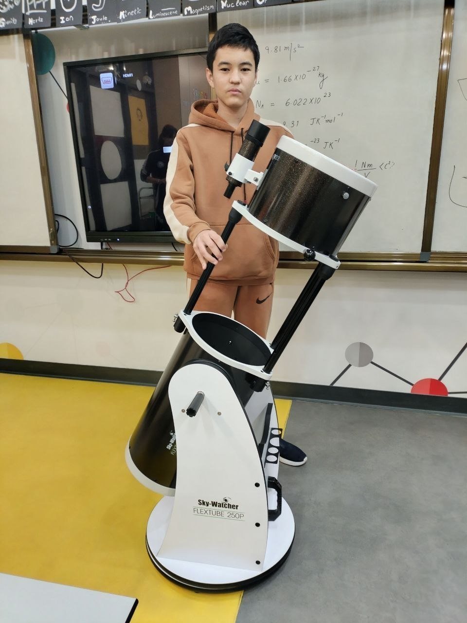 Astrospace Club member with the club's telescope during a session