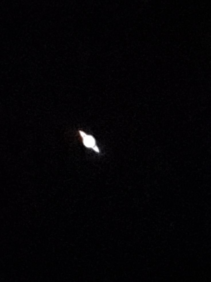 A bright object crossing the night sky above the school